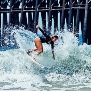surfer surfing near Oceanside Pier